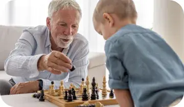 Senior grandfather playing chess with grandson for mental sharpness and memory health